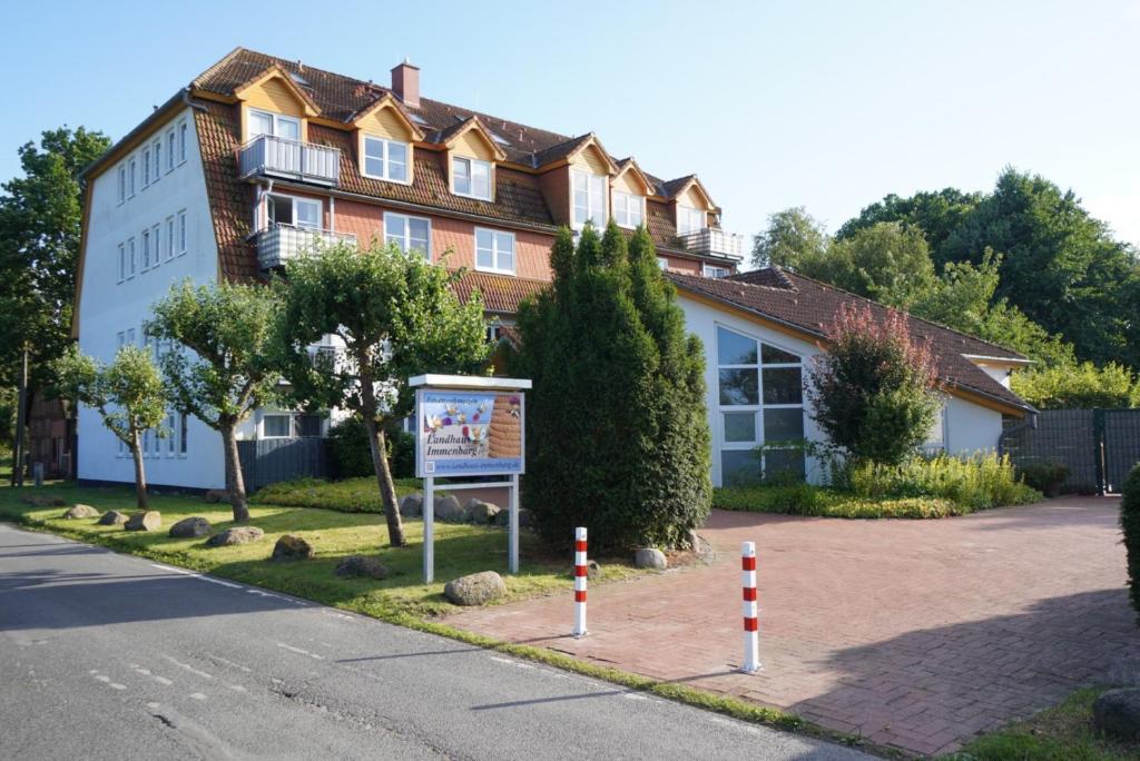 a building with a sign in front of a street at Küstenloft-Leuchturm in Rostock