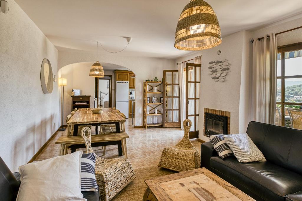 a living room with a couch and a table at Castell Mirto - villa private pool in Calonge