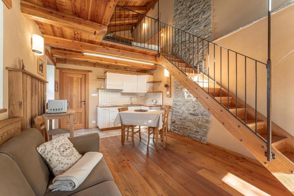 a living room with a staircase and a dining room at Civico 9 in Marmora