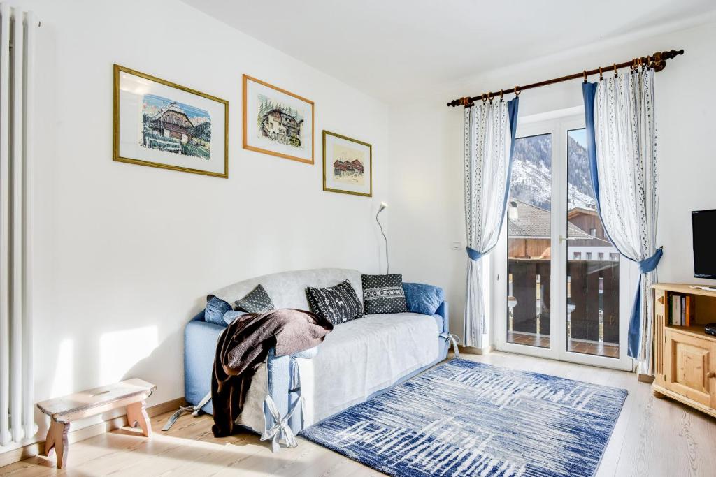 a living room with a couch and a window at Ciasa Christina in Moena