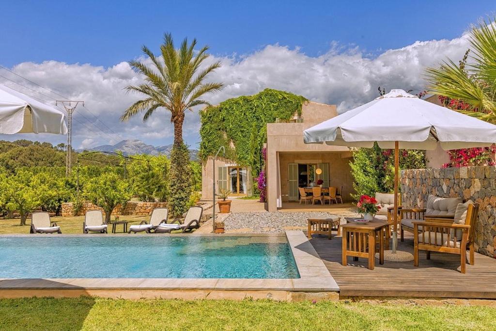 a villa with a swimming pool and a patio at Son Puca 1 in Búger