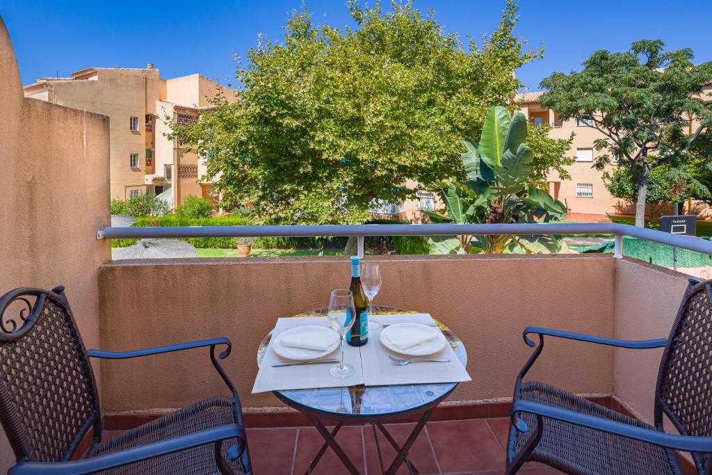 a table and two chairs on a balcony at La Reserva de Alvarito in Marbella