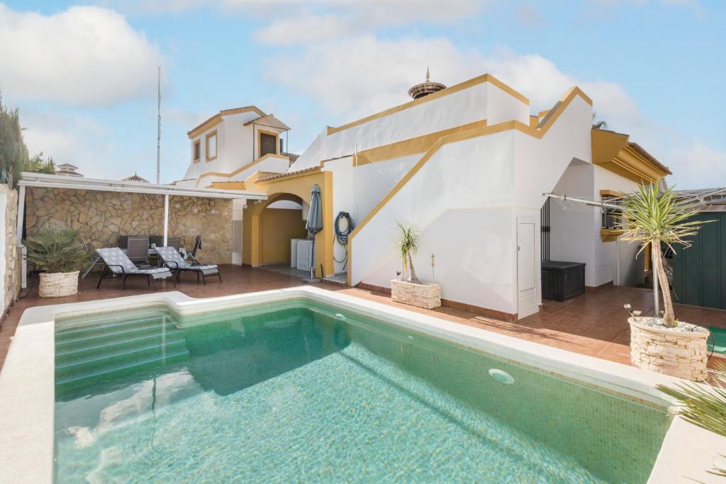 a villa with a swimming pool and a house at Villa Sueño in Mazarrón