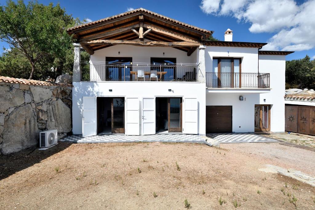 a large white house with a balcony at Casa Ami in Arzana