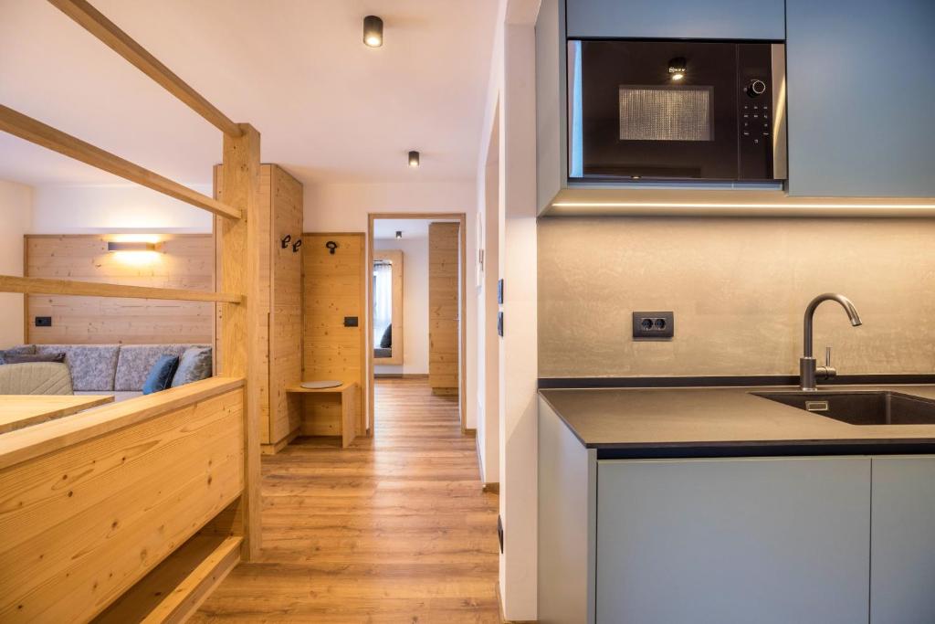 a kitchen and living room in a tiny house at Apartments Armeri Blue Dolomites in San Vigilio Di Marebbe