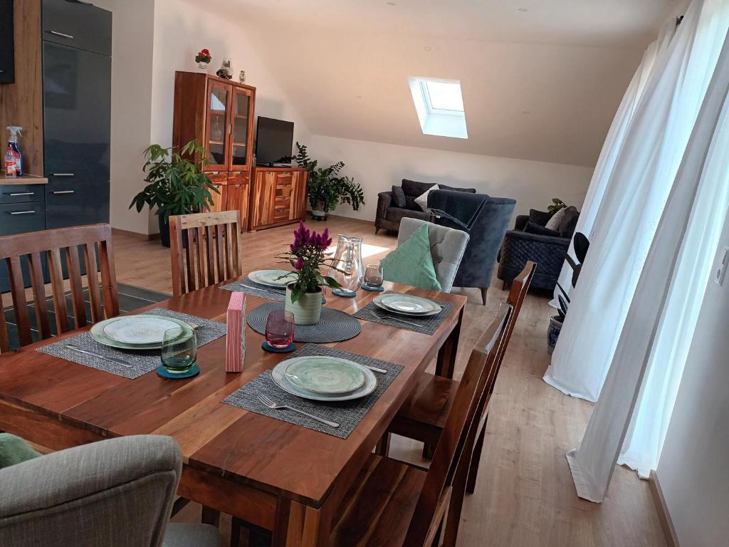 a wooden table in a living room with a dining room at Superior Apartment Waldblick in Westerheim