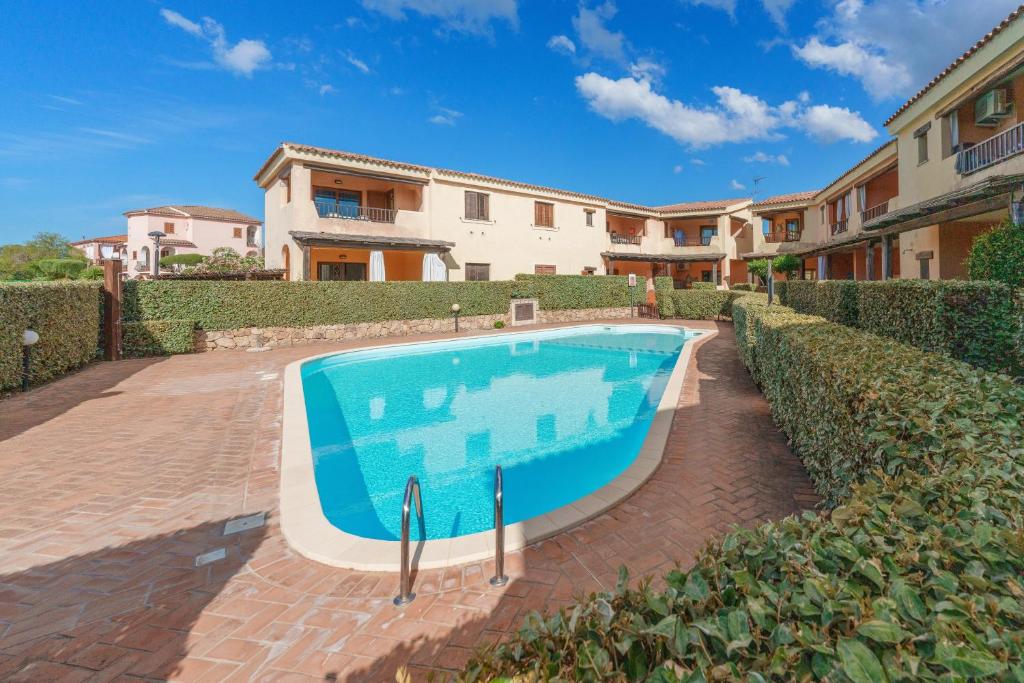 a swimming pool in front of a house at Casa Vacanze Susino in Olbia
