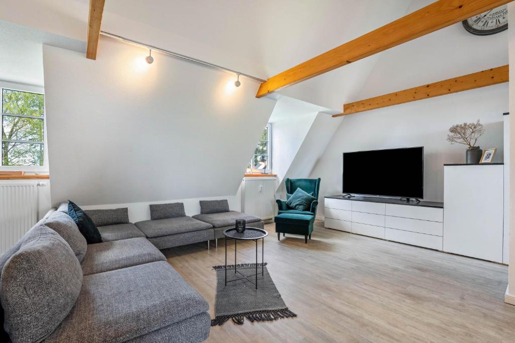 a living room with a couch and a tv at Fehrsland 2 in Dollerup