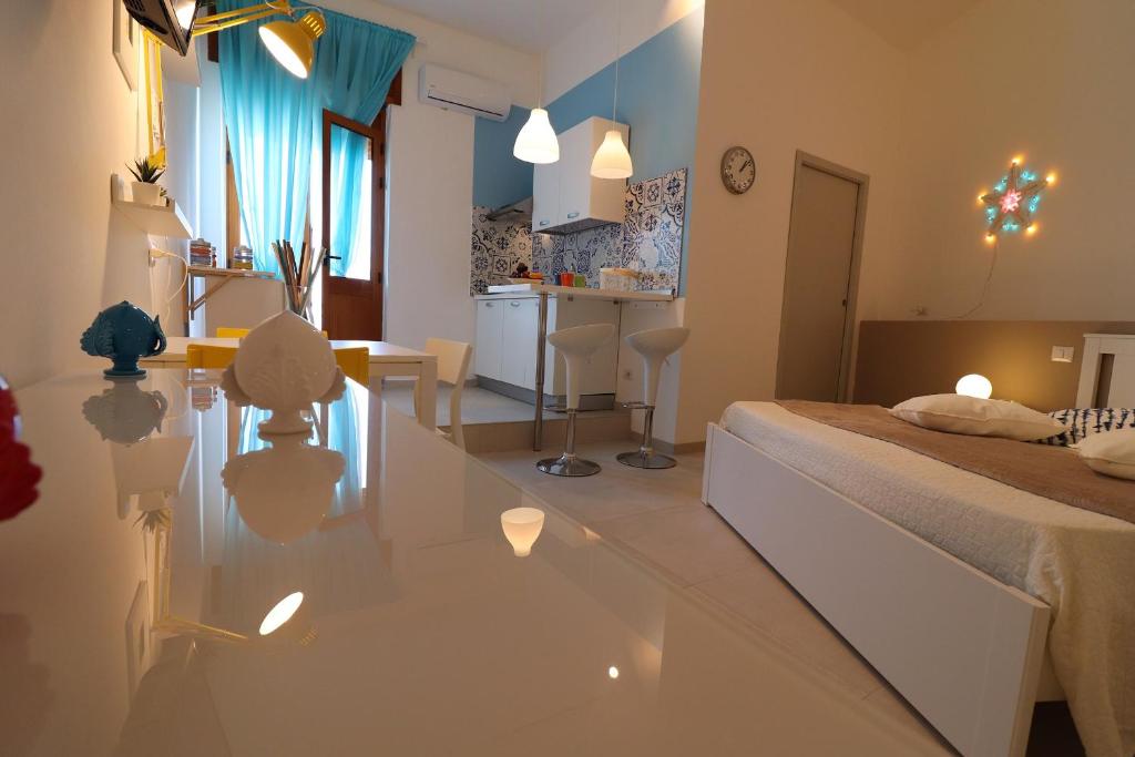 a bedroom with a bed and a table in a room at Casa Vacanze Maya a Otranto in Otranto