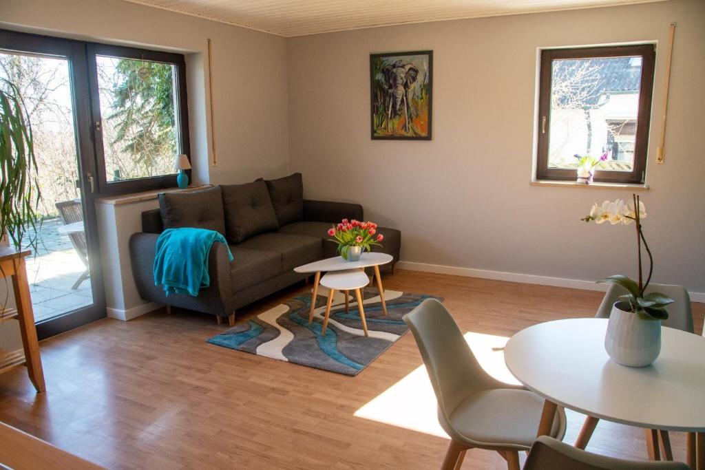 a living room with a couch and a table at Ferienwohnung Maintalblick in Eltmann