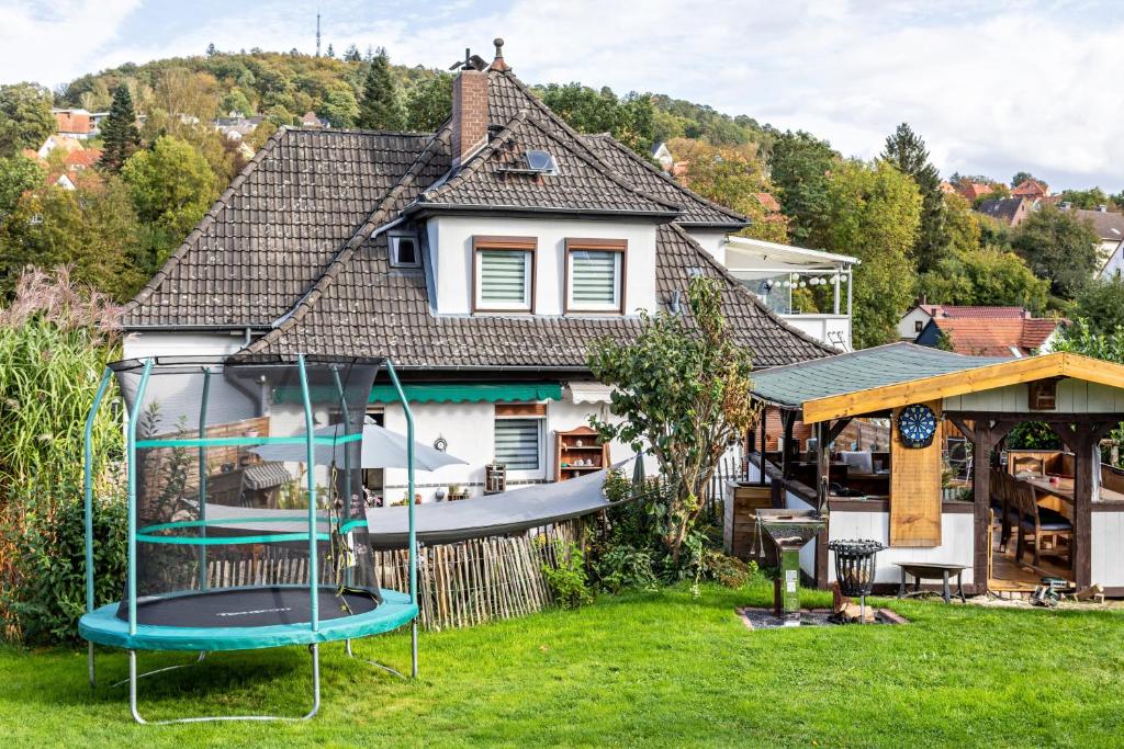 a house with a playground in the yard at Haus am Vogelsang in Hannoversch Münden