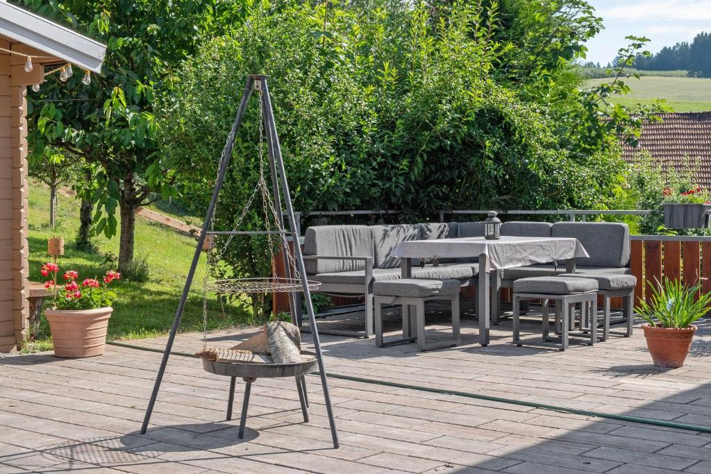 a group of tables and chairs on a patio at Ferienwohnung Landliebe in Biederbach Baden-Württemberg