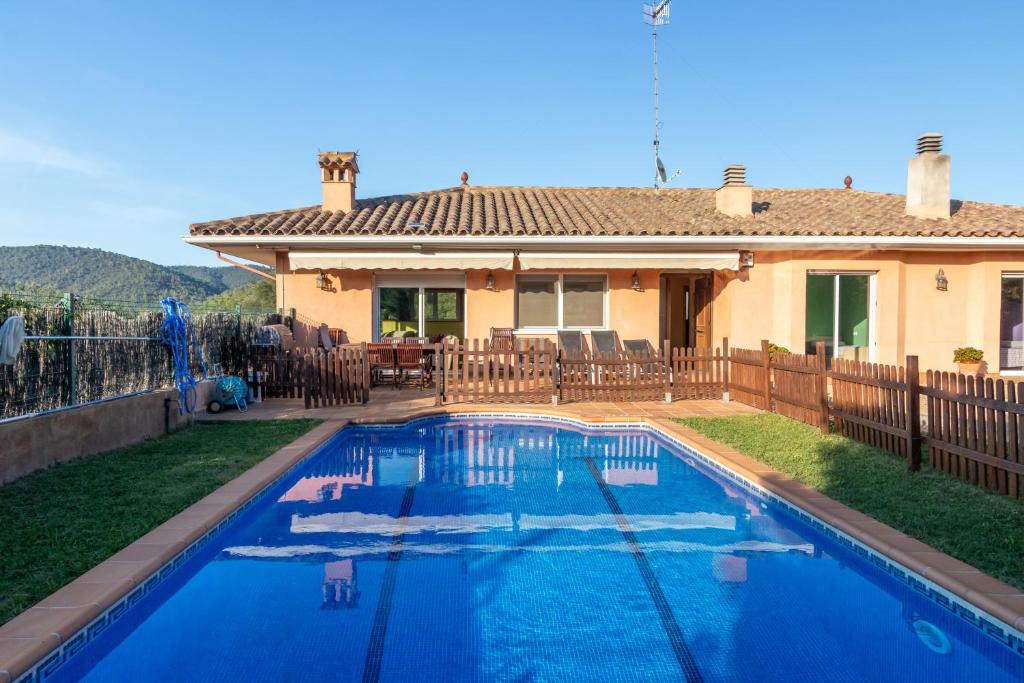a swimming pool in front of a house at Casa con piscina in Calonge