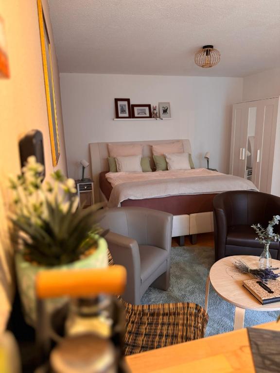 a bedroom with a bed and a living room at Komfort-Apartment Mit Terrasse in Estenfeld