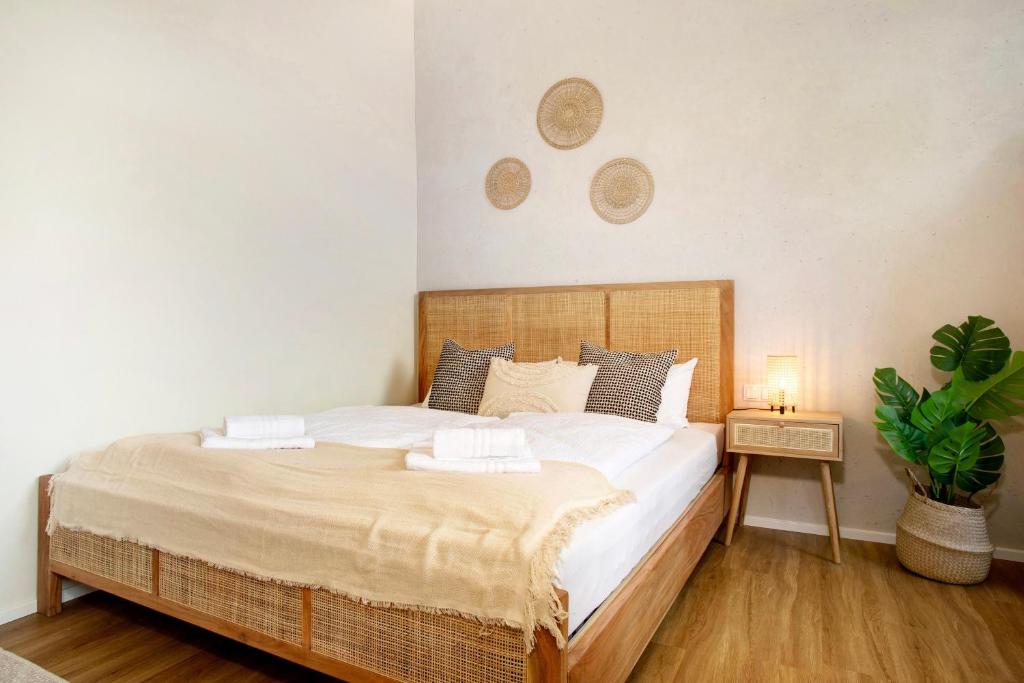 a bedroom with a large bed and a plant at Sonnenblick Bregenz in Bregenz
