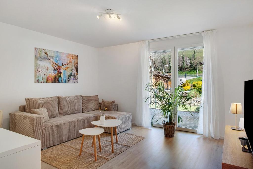 a living room with a couch and a table at Bachblick in Buchenbach