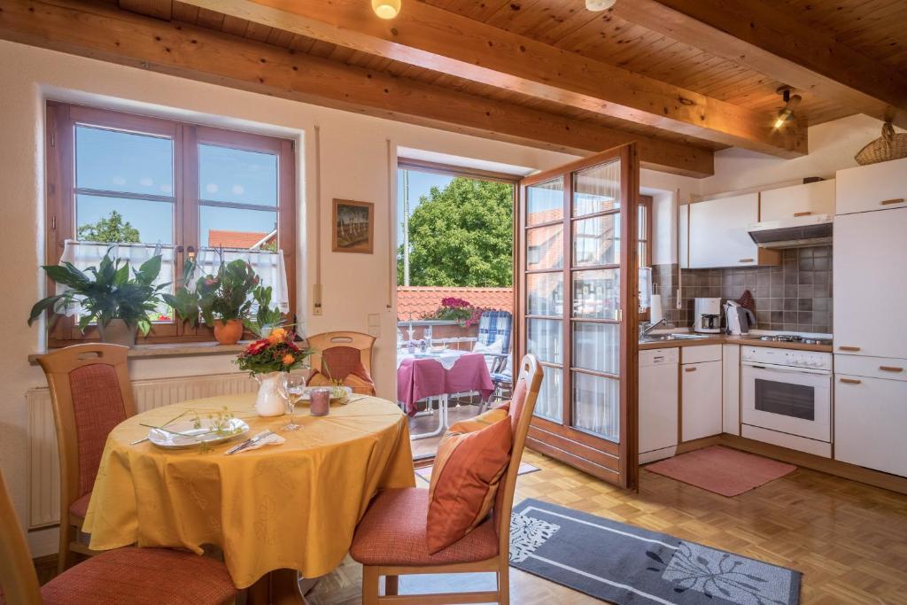 a kitchen and dining room with a table and chairs at Haus Desor in Kressbronn am Bodensee