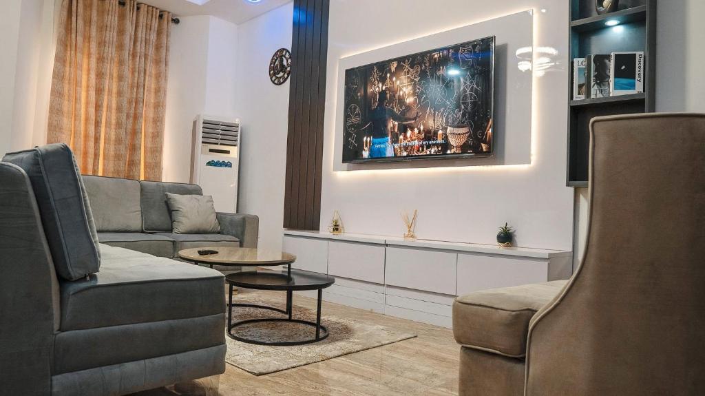 a living room with a couch and a table at Urban Haven - Orchid, Lekki in Lekki