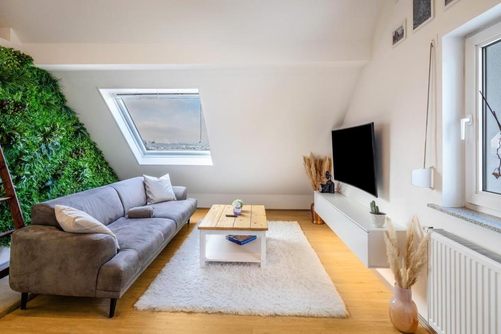 a living room with a couch and a table at Hue Space Air in Kassel