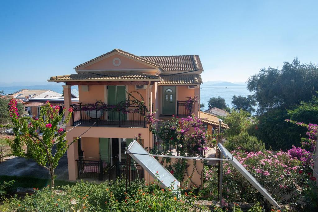 a house with flowers in front of it at Villa Pepy Studio 3 in Mesongi
