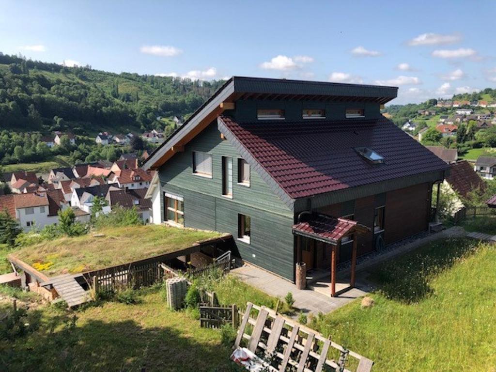 a house on top of a hill with a yard at Haus Leenja in Beverungen