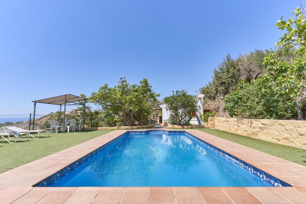 a swimming pool in the backyard of a house at Villa Torrox Costa con Piscina in Torrox