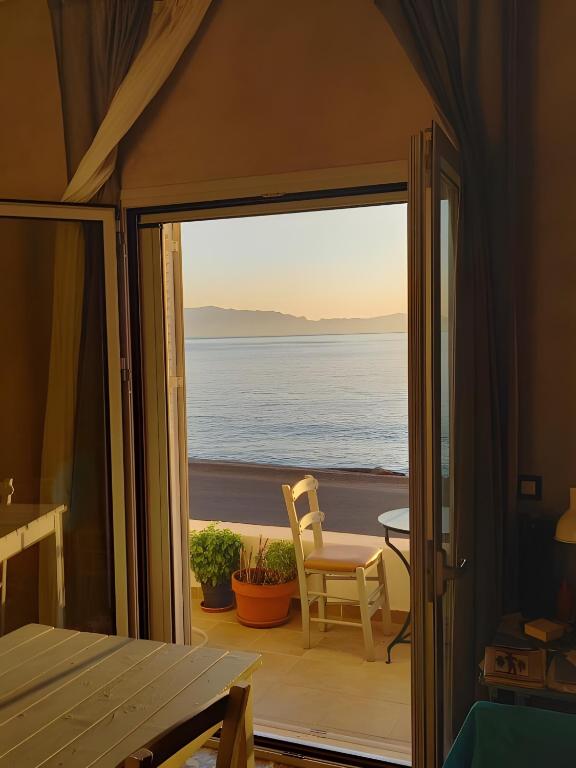 a view of the ocean from the balcony of a house at I have a big dream in Agia Pelagia