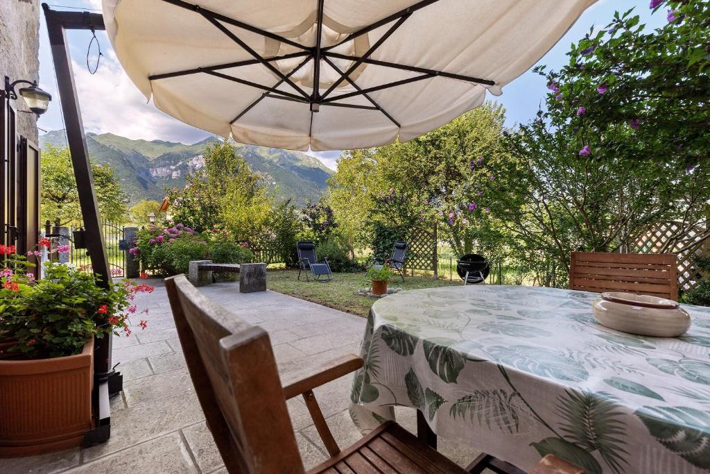 a table with an umbrella on a patio at Antico Casolare di Alice in Cares