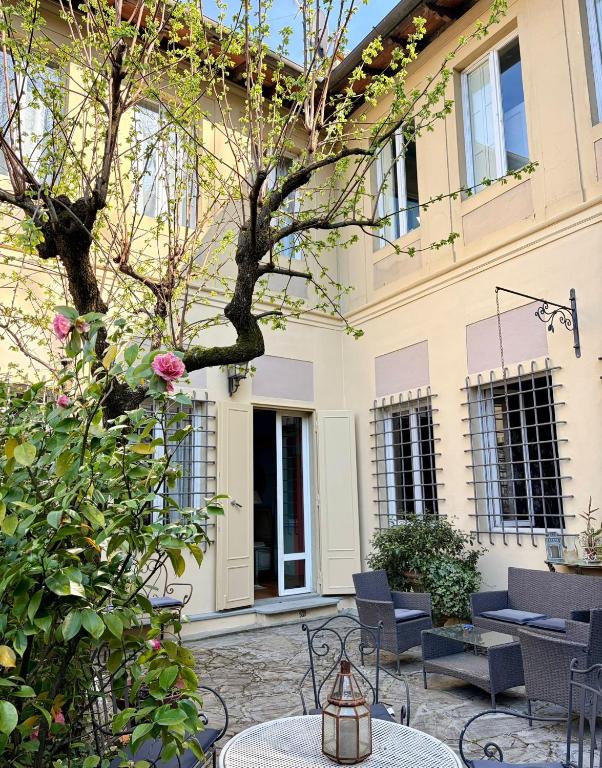 a patio with tables and chairs in front of a building at Villa Angela in Florence