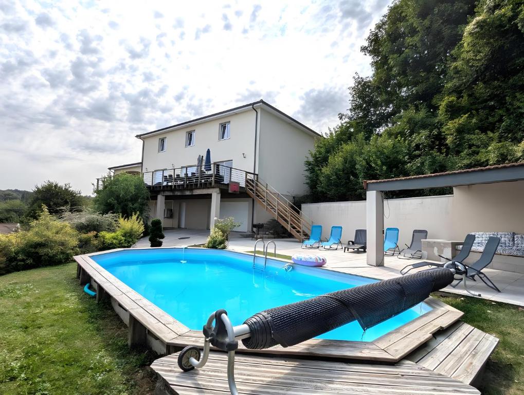 a swimming pool in front of a house at Villa des ermites in Favières