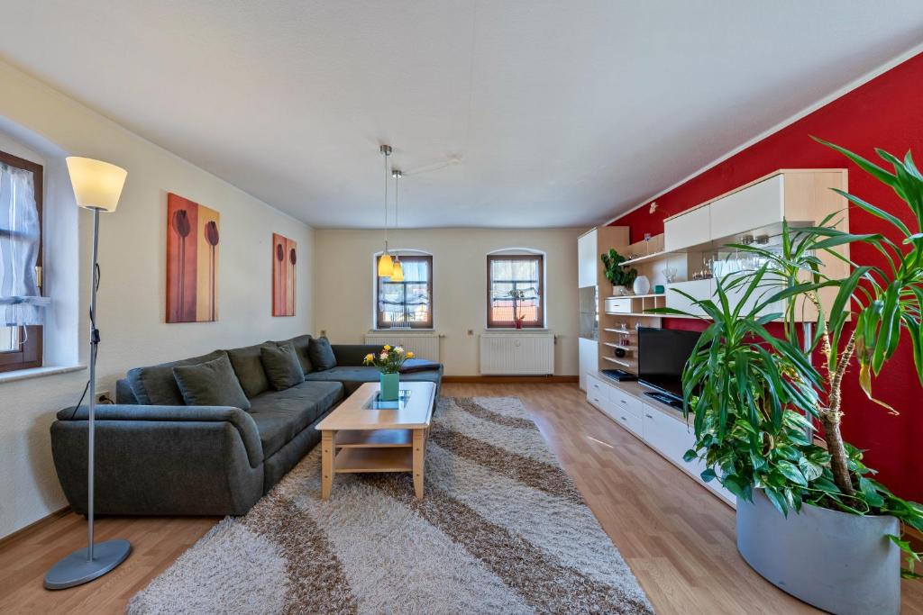 a living room with a couch and a table at Pillnitzer Schlossblick in Dresden