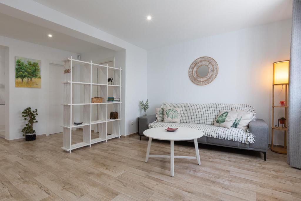 a living room with a couch and a table at Casa La Puente in Mijas