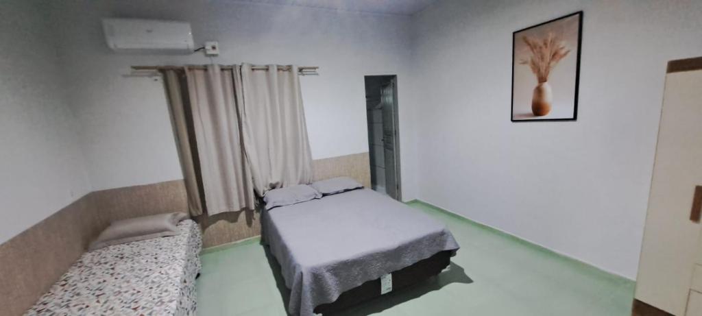 a bedroom with two beds in a room at Flat JM 05 in Parauapebas