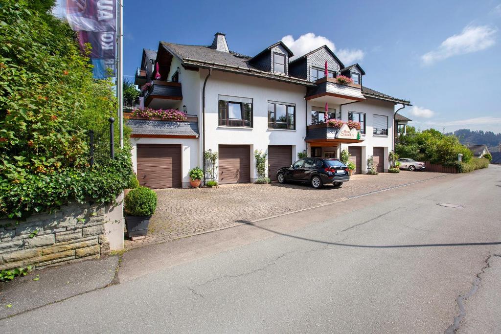 a house with a car parked in front of it at Haus Schönblick in Willingen