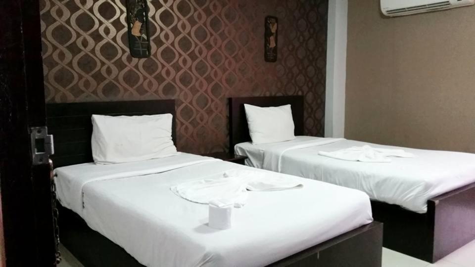 dos camas sentadas una al lado de la otra en una habitación en Pruksa Siri View, en Saraburi