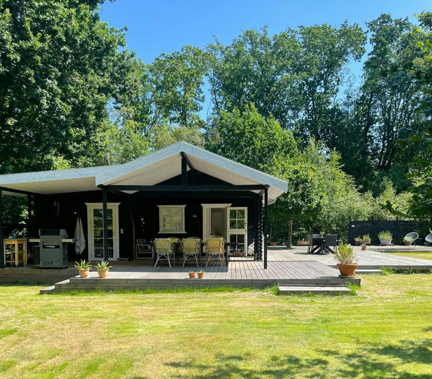 a house with a porch and a patio at Holiday Home By Nyrup Bay And Rørvig Harbour in Rørvig