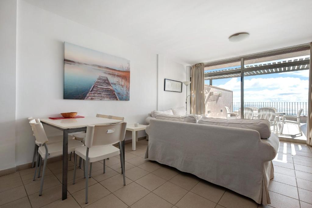 a living room with a couch and a table at Casa Médano 17 in Granadilla de Abona
