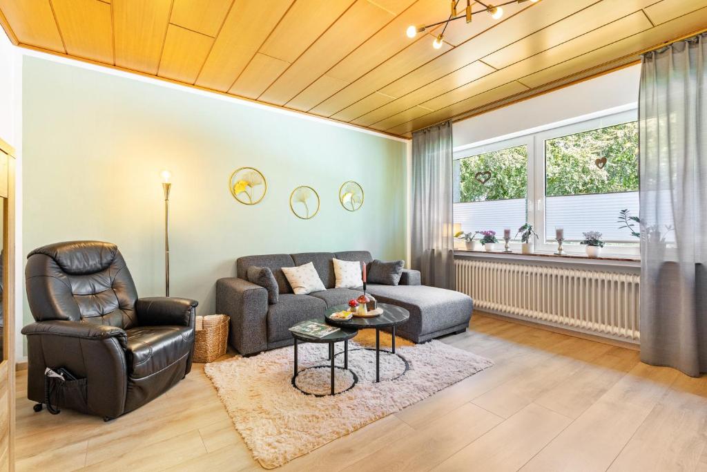 a living room with a couch and a chair at Fewo Mama Mia in Menden
