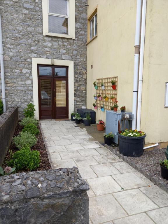 a stone walkway in front of a building with a door at Townhouse in Castleisland