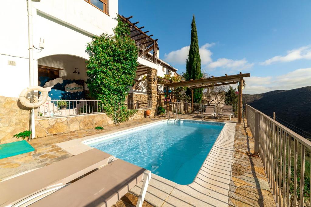 a house with a swimming pool on a balcony at El Mirador in Laroya