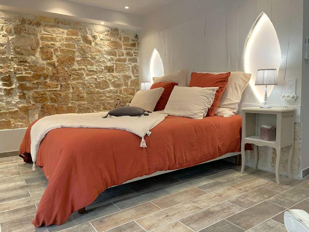 a bedroom with a bed with a cat sitting on it at La Colombière in Salviac