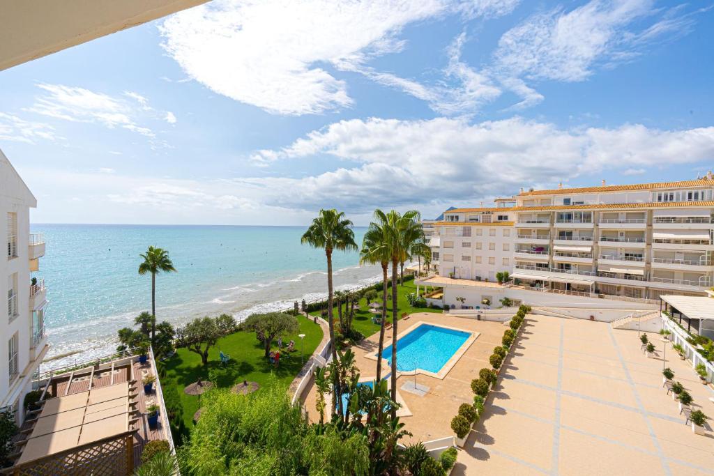 a view of the beach from the balcony of a resort at Costabella Altea in Altea
