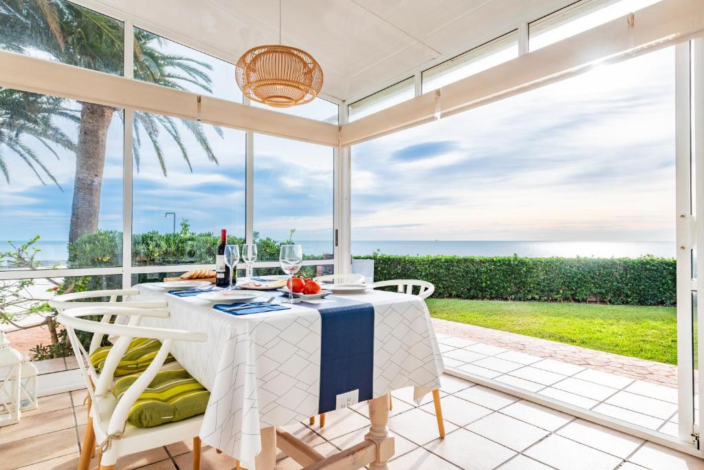 a dining room with a table and chairs with a view of the ocean at Casa Vesalia in Vinarós