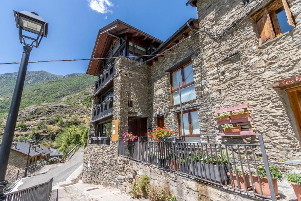 a stone house with a balcony and a street light at Casa Guillem Completa in Tavascan