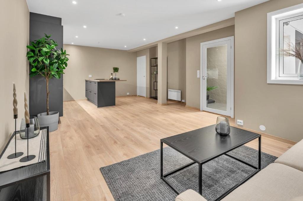 a living room with a couch and a table at Sunny Central in Kristiansand