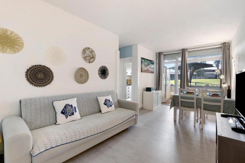 a living room with a couch and a table at Tróia Beach House in Carvalhal