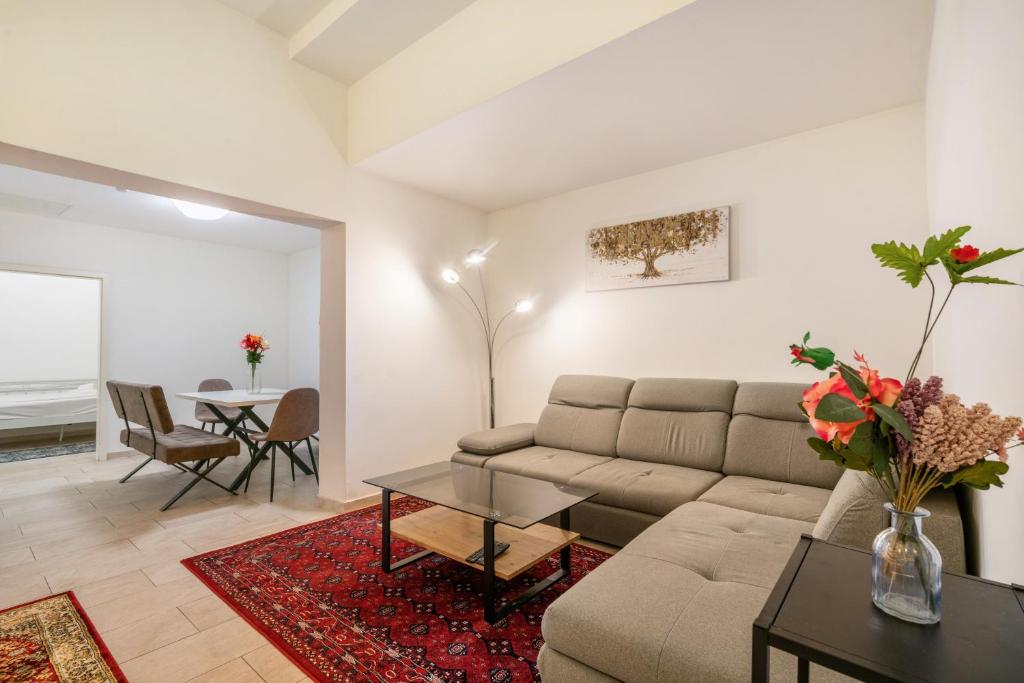 a living room with a couch and a table at Aldars Urban Loft Suite No.8 in Munich