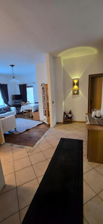 a large living room with a couch and a table at La Locanda dei Nonni in Pozza di Fassa