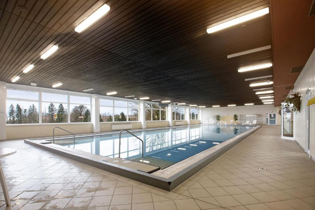 a large swimming pool in a large building at Panoramablick über den Oberharz in Braunlage