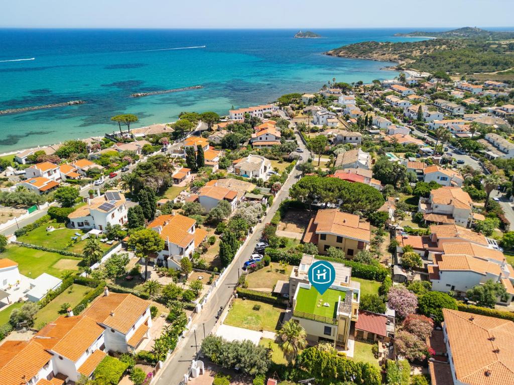 an aerial view of a suburb with houses and the ocean at Nuràya in Sarroch
